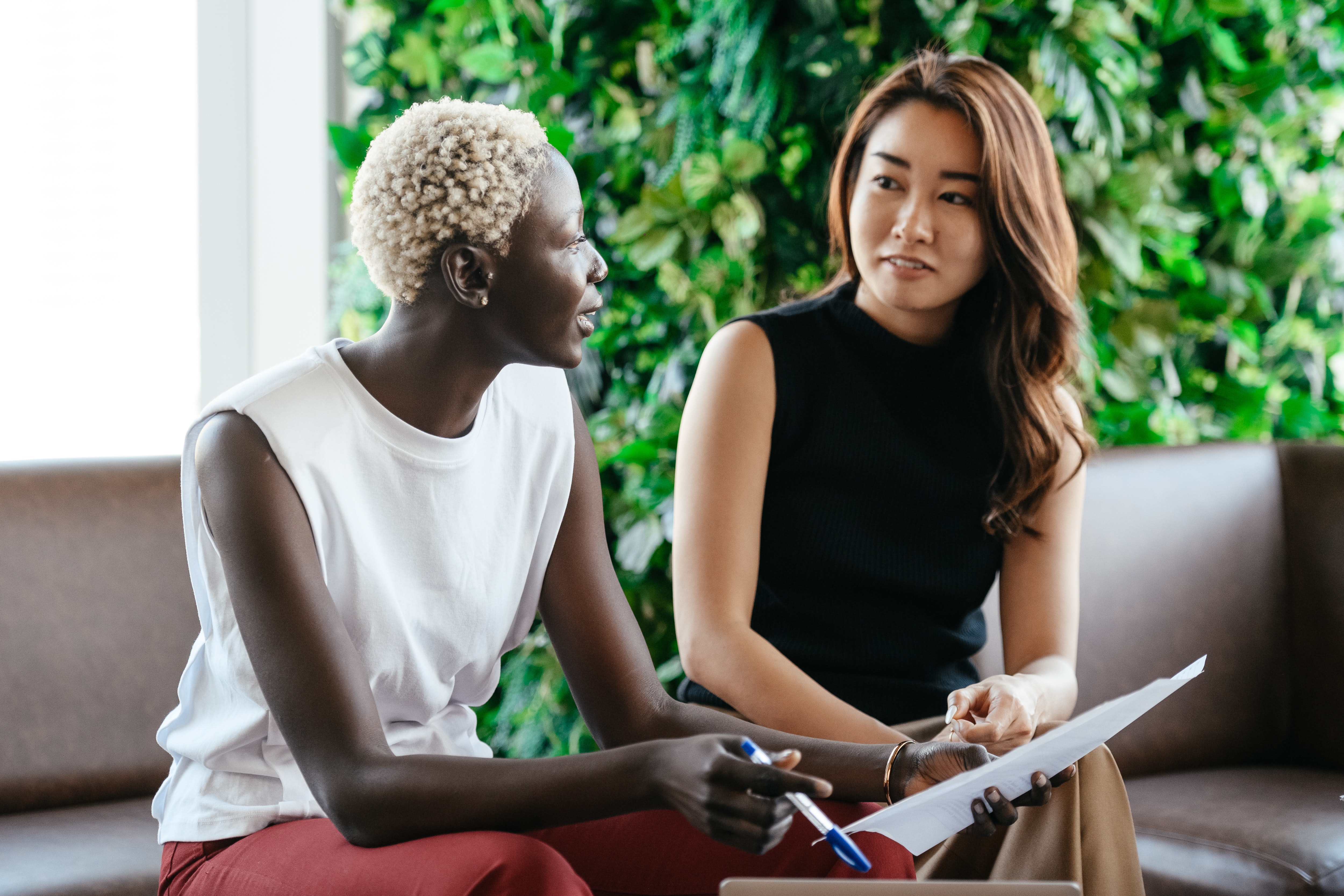 two business woman talking to each other