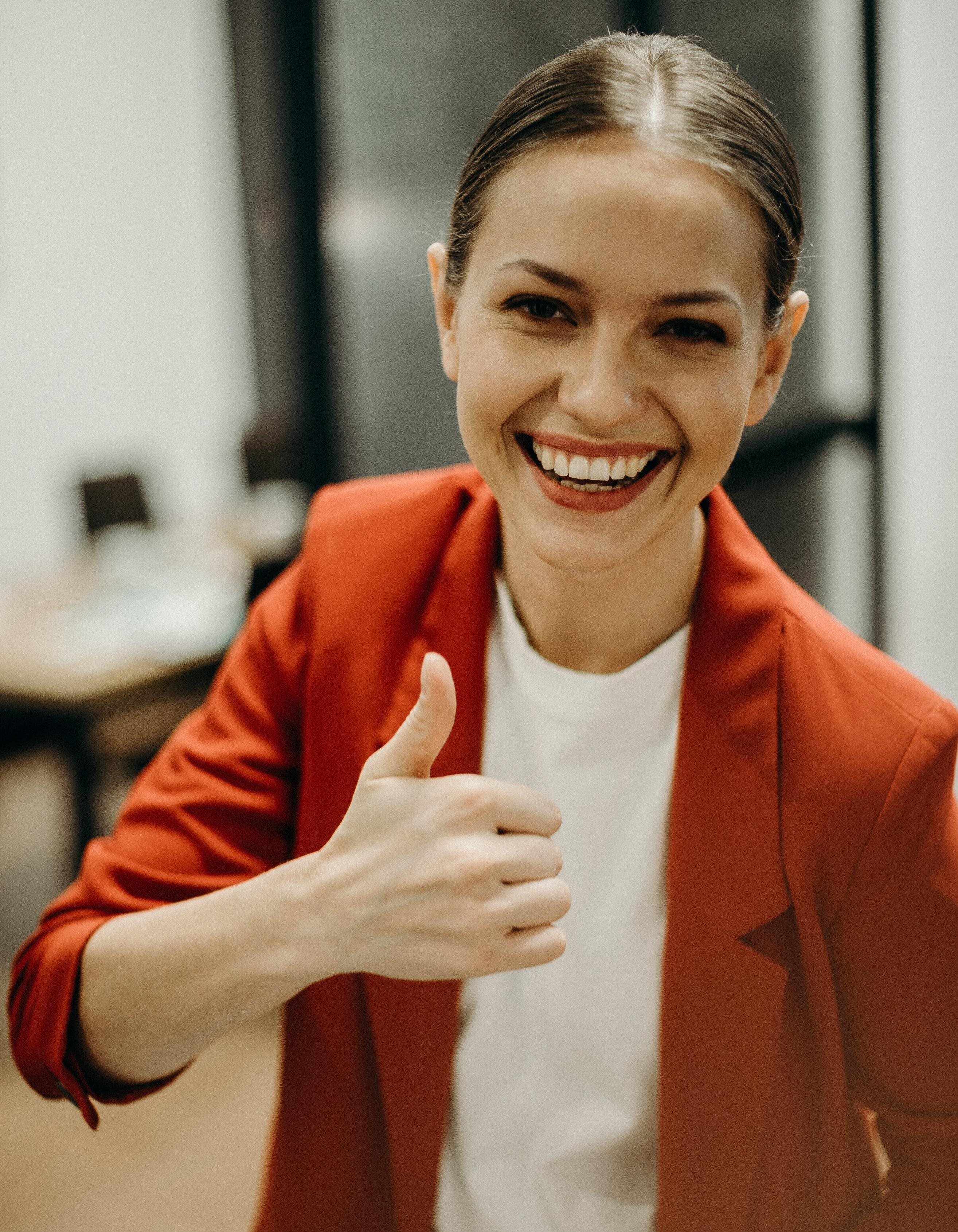Smiling woman showing thumps up