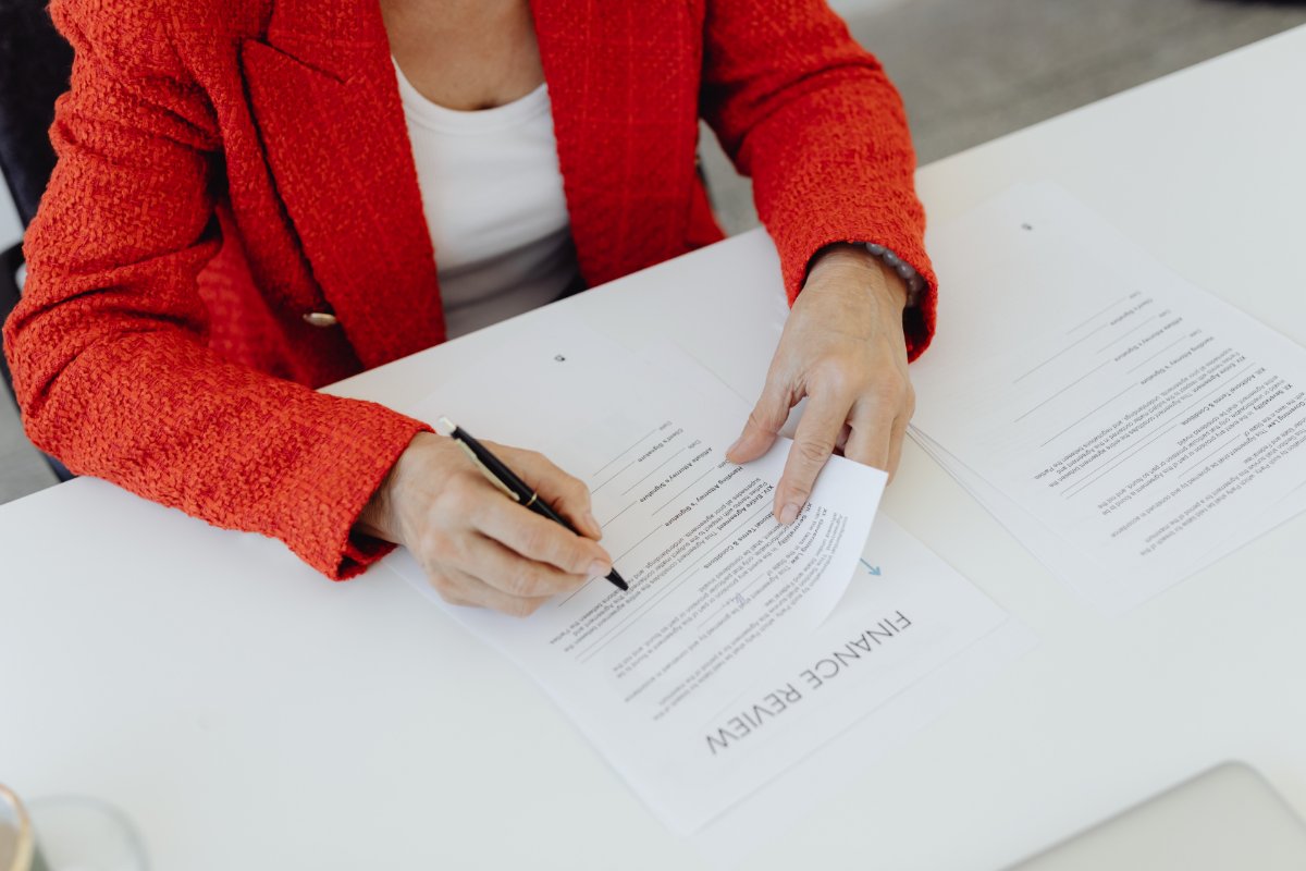 woman reading and singning a contract
